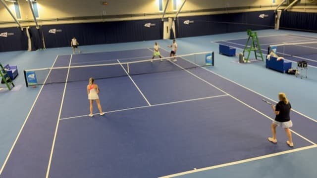 Volley drills on an indoor court at the NTC