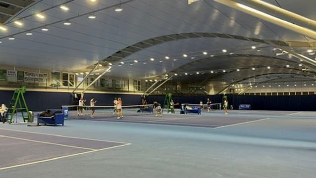 Serving practice on an indoor court at the NTC