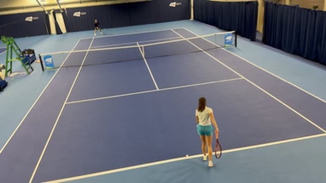 Live point play on an indoor court at the NTC