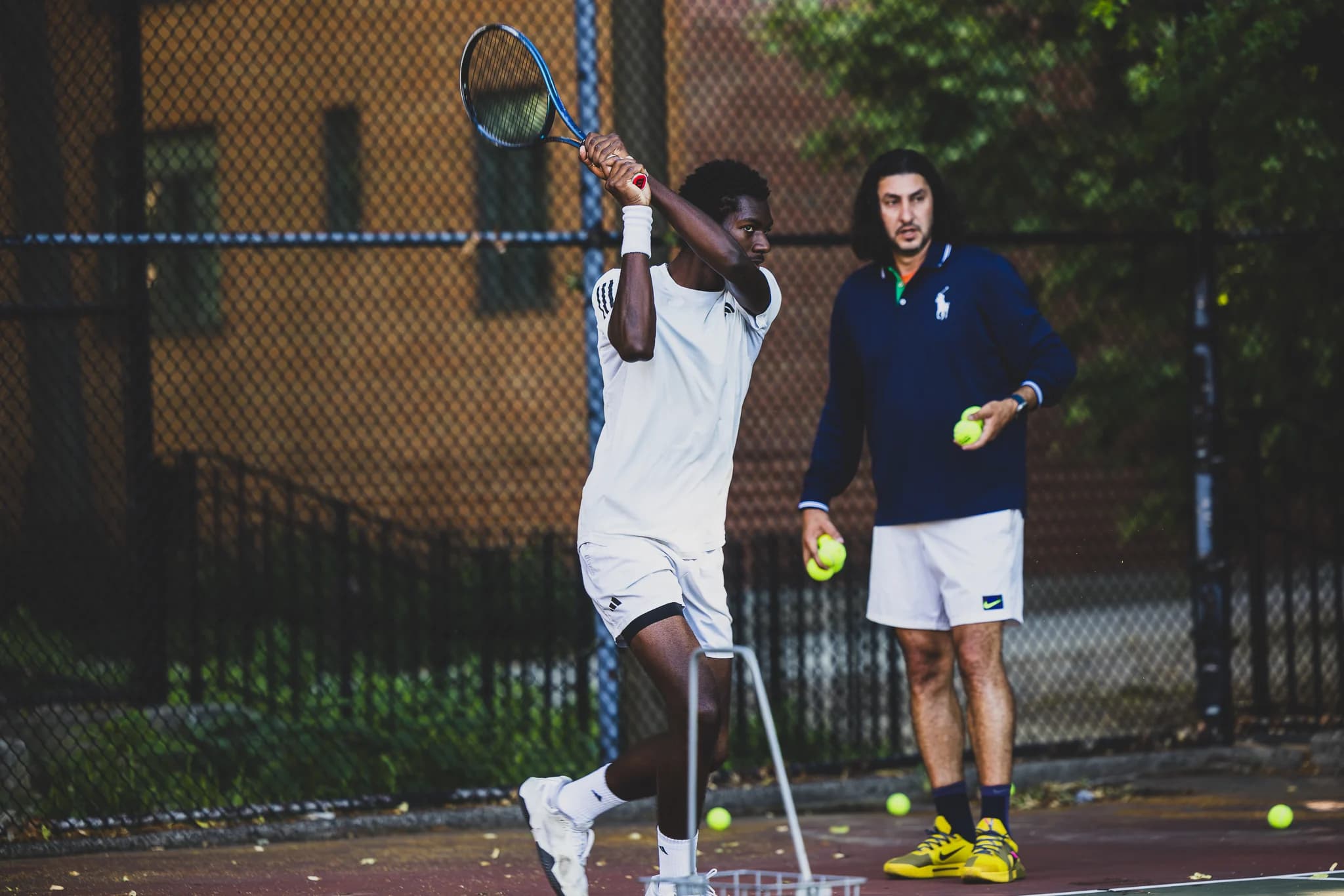 Farhad Roshanaie coaching a local player at Frederick Johnson Playground.