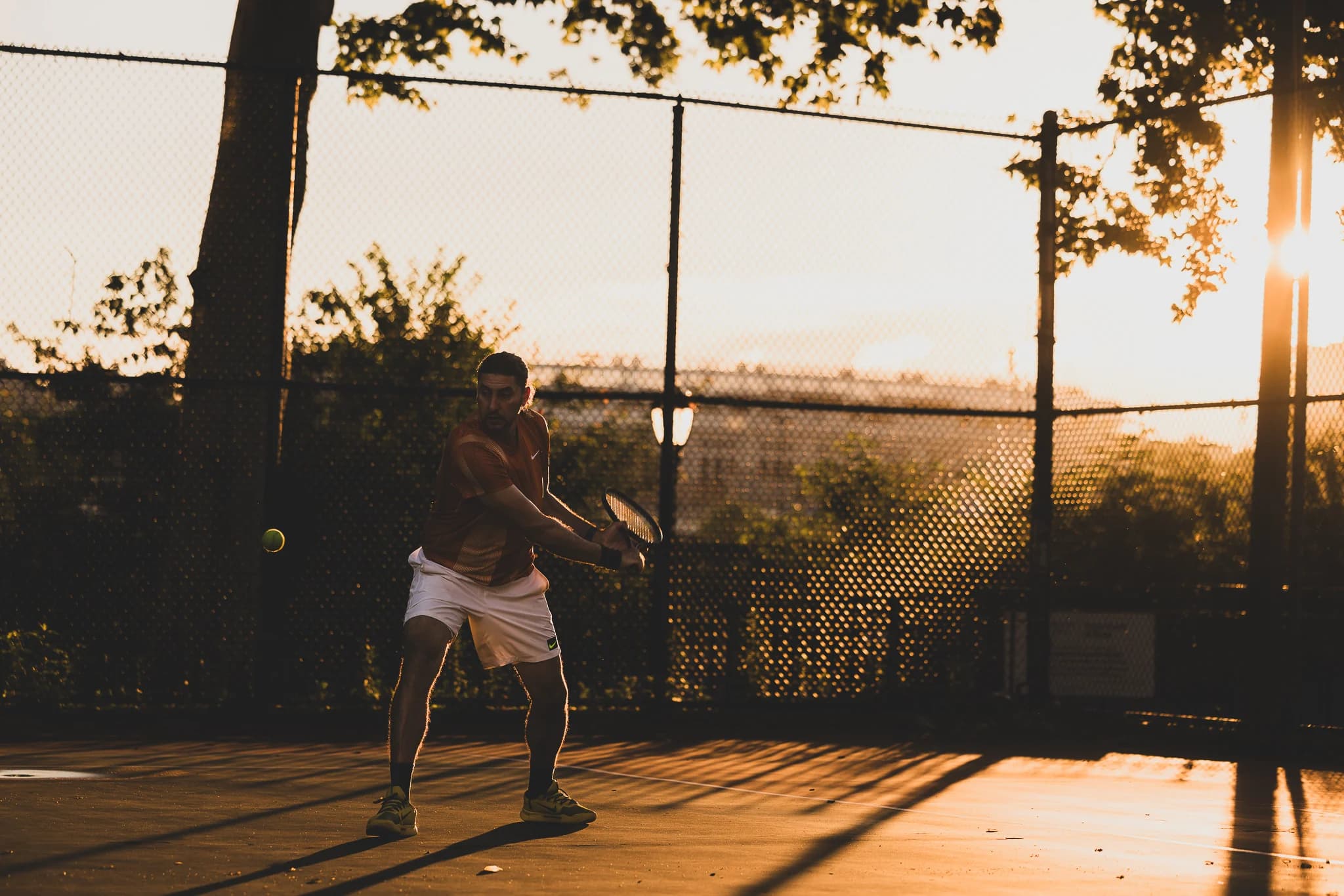 Farhad Roshanaie training at dusk on the Frederick Johnson courts.